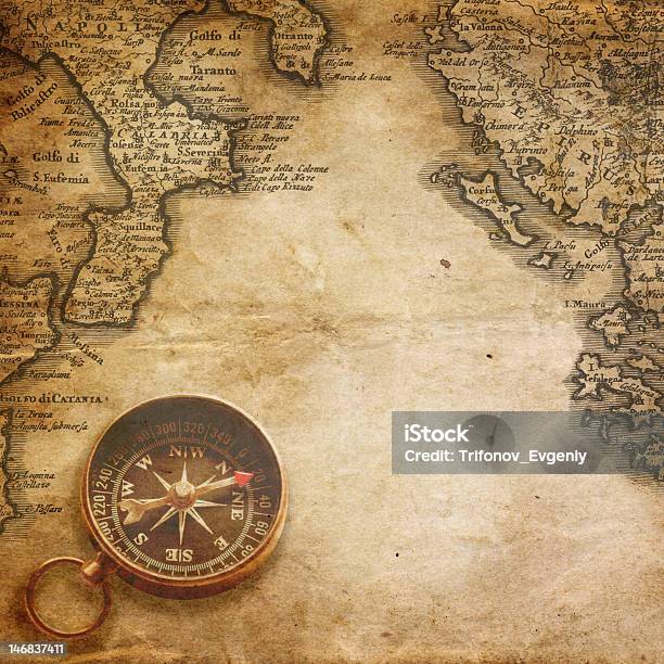 An Old Compass On An Old Yellowed Map Stock Photo - Download Image Now - The Past, Ancient, Antiquities