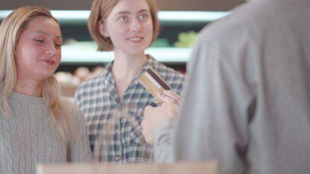 istock Fast and convenient spending. Credit card transactions. Multi Ethnic people enjoy to shopping for consumer goods in supermarket at shopping mall and paying using credit card contactless payment with cashiers. Spending money with wireless transaction. 1468375039