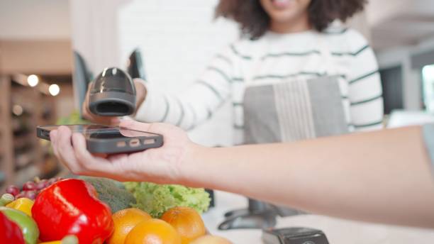 istock Contactless payment with your smartphone. Wireless payment concept. Close-up, woman using smartphone cashless wallet NFC technology to pay order on supermarket. Lifestyle in spending digitally with a modern and comfortable life. 1468375084