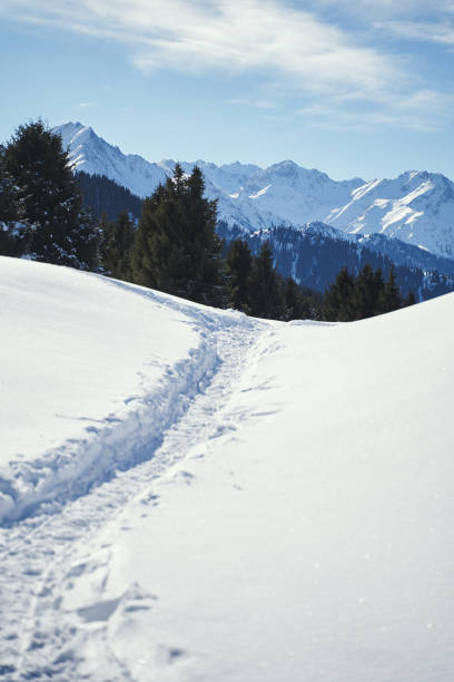 istock Mountain narrow path covered with snow near the mountain range. 1468376230