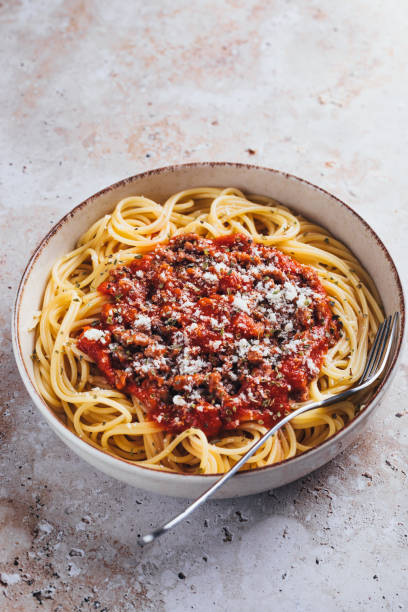 istock High angle view of spaghetti with bolognese sauce on stone background. 1468376252