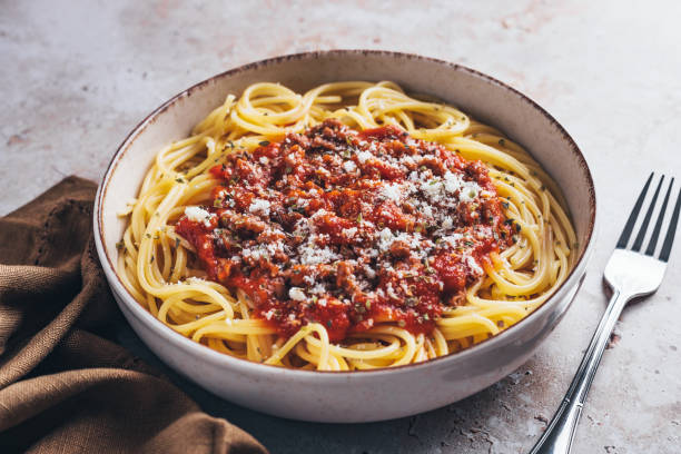istock High angle view of spaghetti with bolognese sauce on stone background. 1468376253