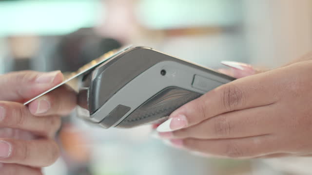 Close up shot. Customer use credit card pay contactless with credit card reader machine at cafe, restaurant or supermarket. Enjoying lifestyle in spending digitally, with a modern and comfortable life. Owner small business, cashless technology.