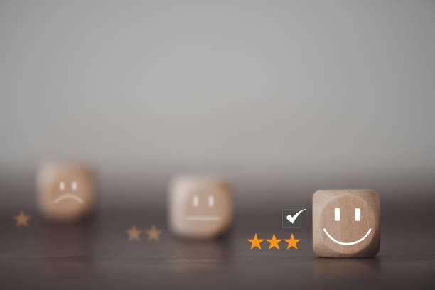 istock The best excellent business services rating customer experience. Chooses a smiley face on a wood block cube. 1468377313
