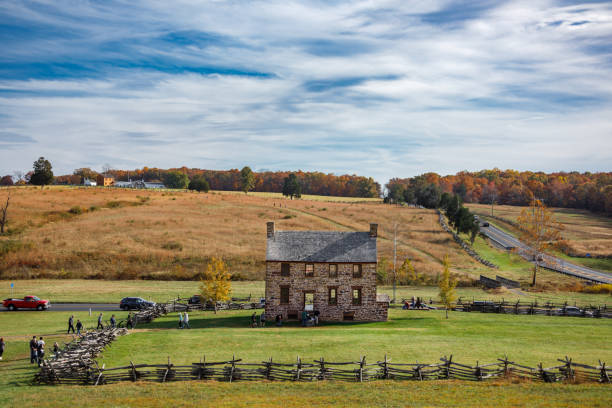 Manassas, VA USA - October 30, 2022: The Stone House at Manassas National Battlefield Park, a site of the US Civil War, with the Henry Hill Visitor Center at the top of the hill