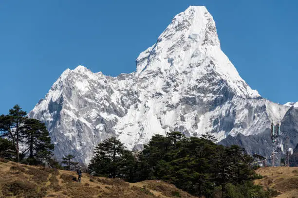 Photo of Tourist standing on the hill and looking to beautiful view of Mt.Ama Dablam (6,812 m).
