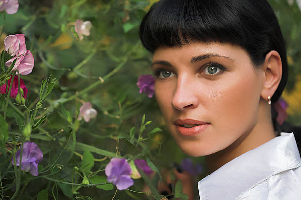 Beautiful young woman and flowers stock photo