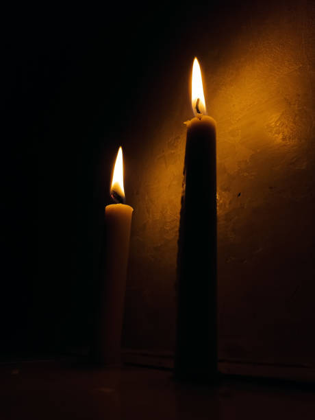 istock two candles lit in the dark 1468392731