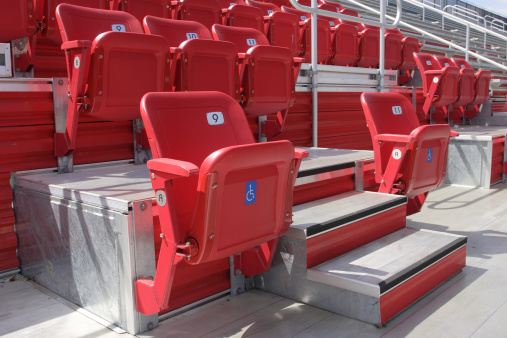 Fold-up red plastic seats in a stadium