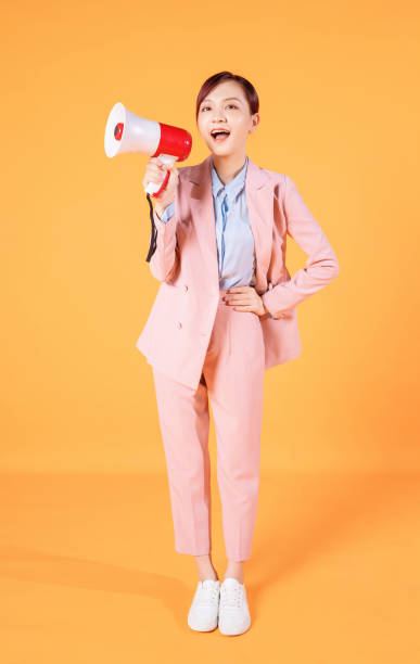 photo of young asian businesswoman holding megaphone on background - filipino ethnicity audio imagens e fotografias de stock