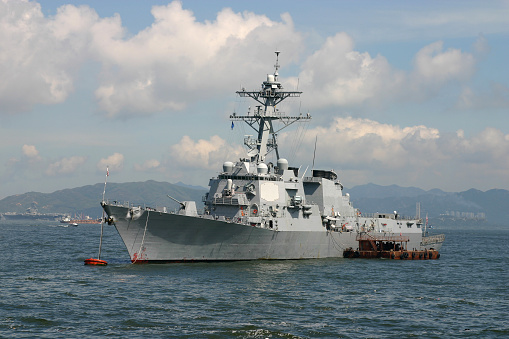 A grey navy warship anchored at sea