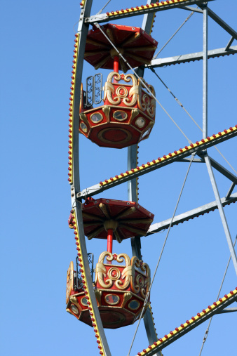 detail from big ferris wheel at amusement park and blue sky