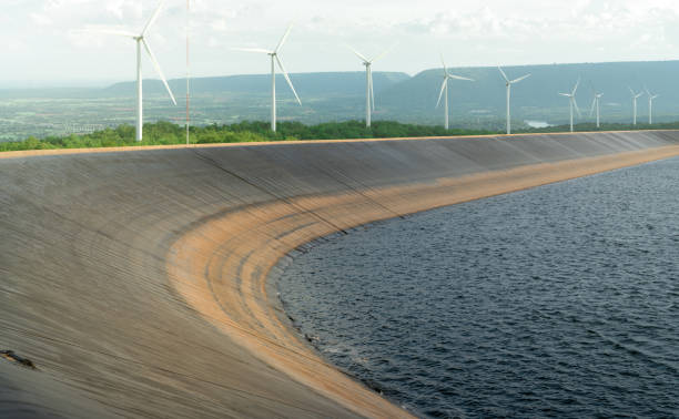 HDPE plastic lined water reservoirs and landscape of wind farm for power generating stations. High density polyethylene engineering material. Wind power. Sustainable, renewable energy. Windmill farm. depósitos de agua revestidos de plástico hdpe y paisaje de parque eólico para centrales generadoras de energía. material de ingeniería de polietileno de alta densidad. energía eólica. energía sostenible y renovable. parque de molinos de viento.