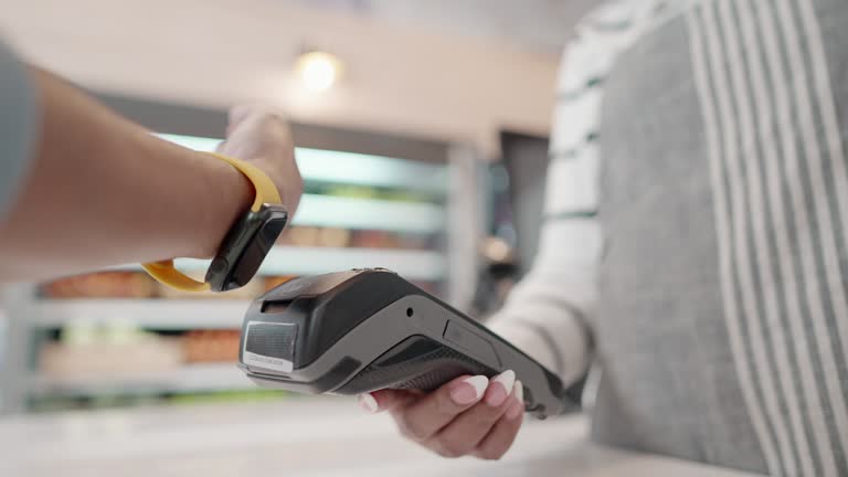 Enjoying lifestyle in spending digitally with a modern and comfortable life. Customer use smart watch pay contactless with credit card reader machine at supermarket. Cashless technology and money transfer, small business, start up concept.