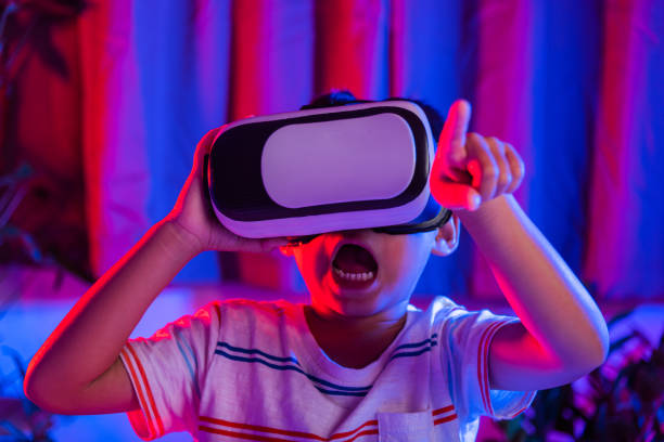 istock Asian little kid boy wearing virtual reality goggles experiencing reality 1468403133