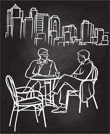 Business men talking while sitting outside at a restaurant terrace