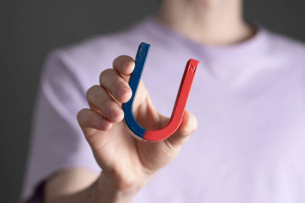 istock student holding a blue and red magnet in shape of horseshoe, making science tests 1468405311