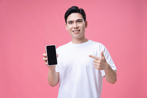 Young Asian man using smartphone on background