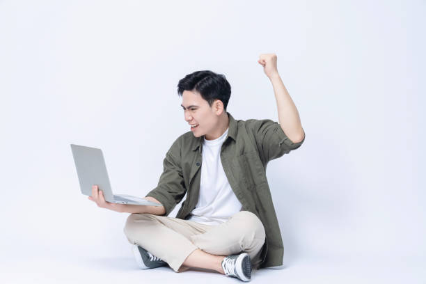 istock Young Asian business man sitting and using laptop on background 1468408195
