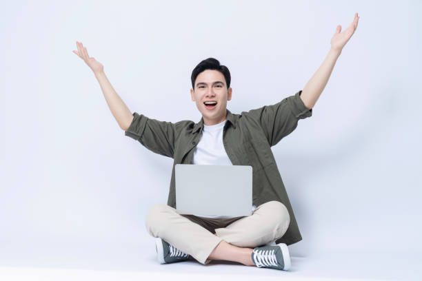 istock Young Asian business man sitting and using laptop on background 1468408208