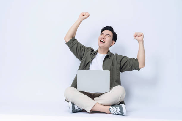 istock Young Asian business man sitting and using laptop on background 1468408210
