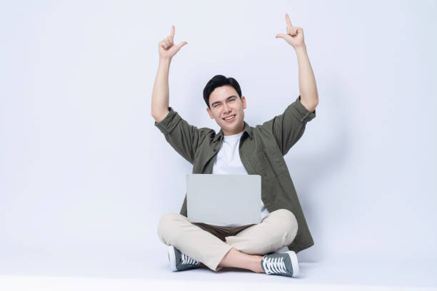 istock Young Asian business man sitting and using laptop on background 1468408211