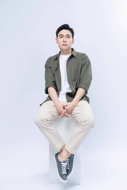 istock Young Asian man sitting on background 1468408230