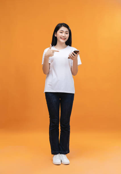 istock Young Asian girl using smartphone on background 1468408391