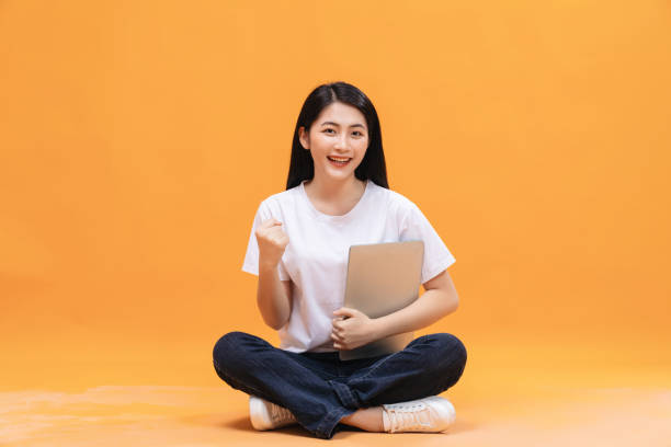 istock Young Asian girl using laptop on back ground 1468408425
