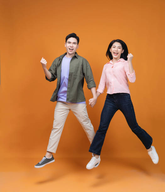 istock Young Asian couple standing on background 1468408679