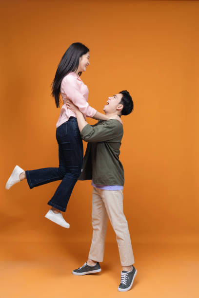 istock Young Asian couple standing on background 1468408694