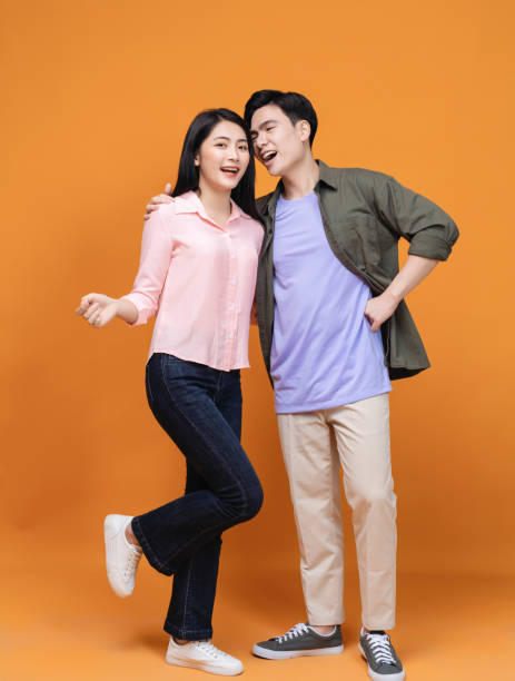 istock Young Asian couple standing on background 1468408707
