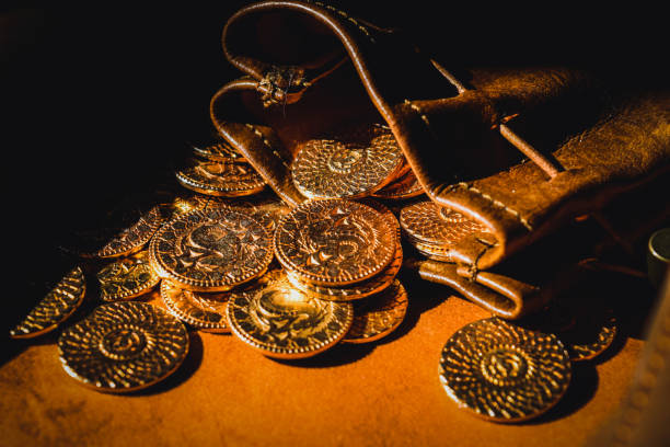 istock a pile of gold-colored coins on a table. 1468409898