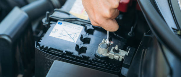 istock A man is maintenance on his car, checking and change the battery. Car maintenance concept. 1468414089