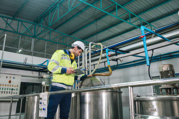 istock Caucasian technician engineer man in uniform with tablet checking and control boiler tanks and liquid pipeline in chemical factory production line 1468425566