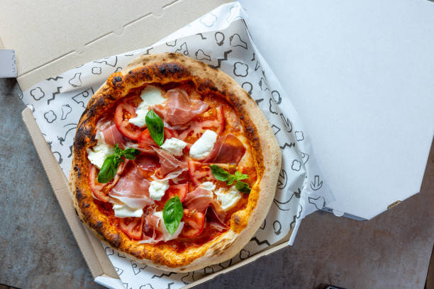 Pizza in open box for delivery stock photo