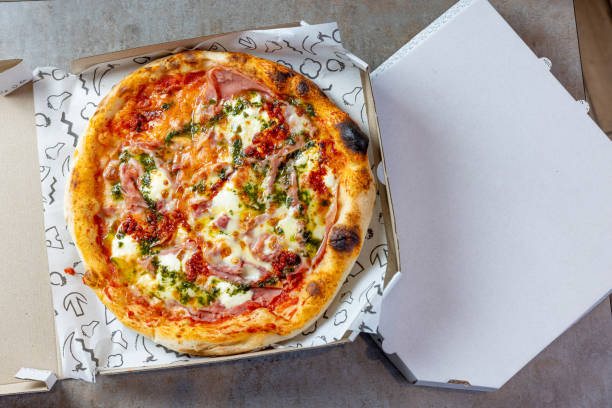 istock Round baked Ham & Cheese pizza in open pizza box 1468429072