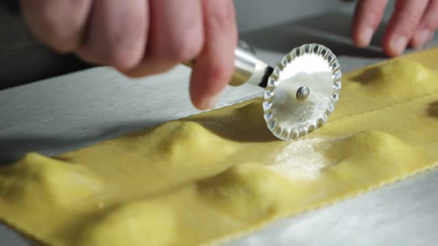 Ravioli Pasta Cut. Preparing ravioli with ricotta. Chef man prepare fresh made ravioli inside pasta factory