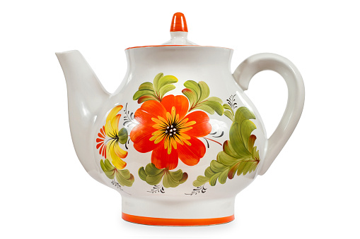 Porcelain teapot with a floral pattern on a white background. The kettle is isolated on a white background.