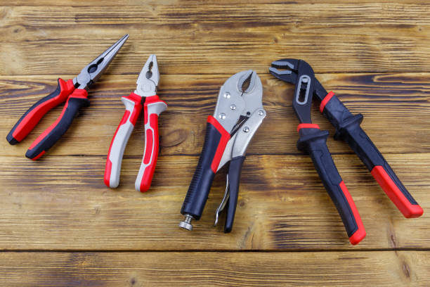 istock Set of different pliers on wooden background. Top view 1468433022