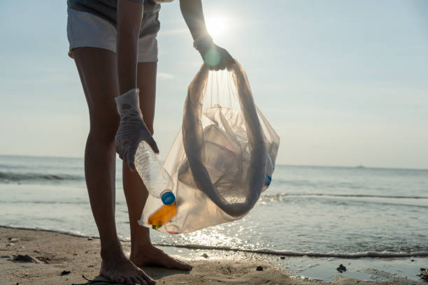 istock Save water. Volunteer pick up trash garbage at the beach and plastic bottles are difficult decompose prevent harm aquatic life. Earth, Environment, Greening planet, reduce global warming, Save world 1468435269
