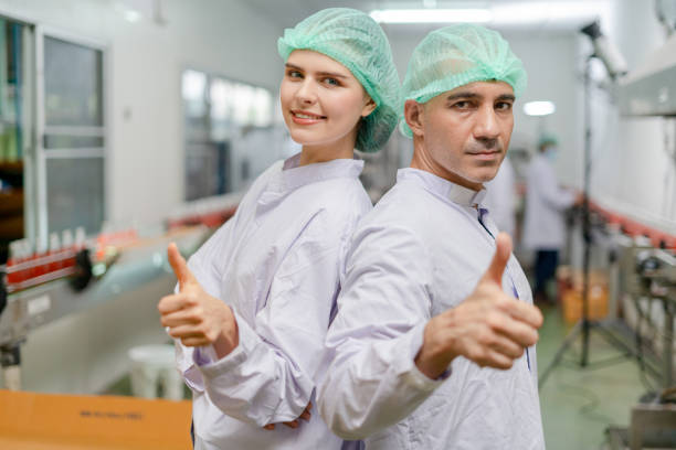 istock portrait quality supervisor or food or beverages technician team thumbs up quality control food or beverages before send product to the customer. Production leader , Quality assurance, staff team. 1468435315