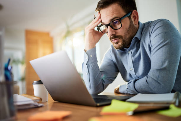 istock Worried businessman working on a computer at home office. 1468435516