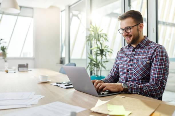 istock Happy businessman working on laptop in the office. 1468437535