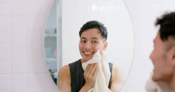 istock man wiping face with towel 1468441695