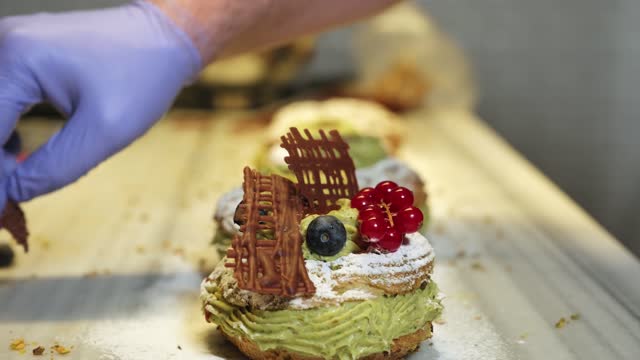 Paris Brest, a classic French dessert consist of large baked ring of choux pastry, filled with soft Pistachio and hazelnut cream topped with roasted Pistachio and hazelnut.