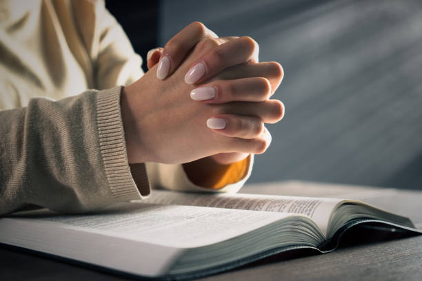 istock Woman praying on bible 1468443393