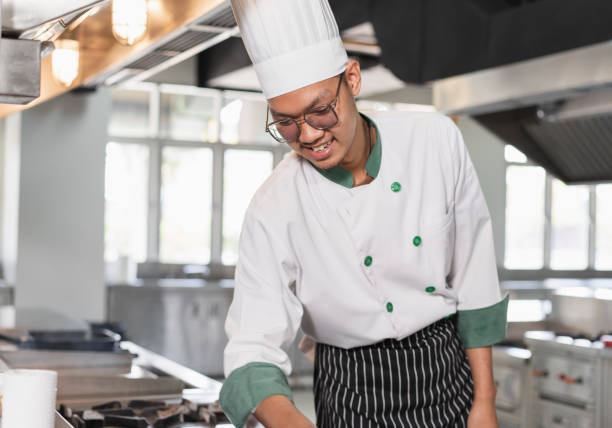 istock Portrait Asia young man in chef uniform at kitchen 1468444561
