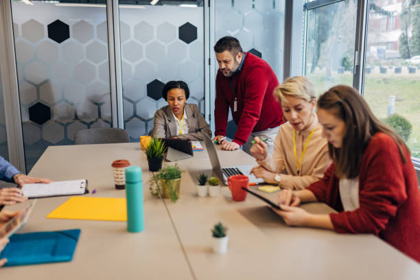 istock Leadership, planning and talking about ideas with marketing, advertising or finance team using tablet in corporate office 1468447033