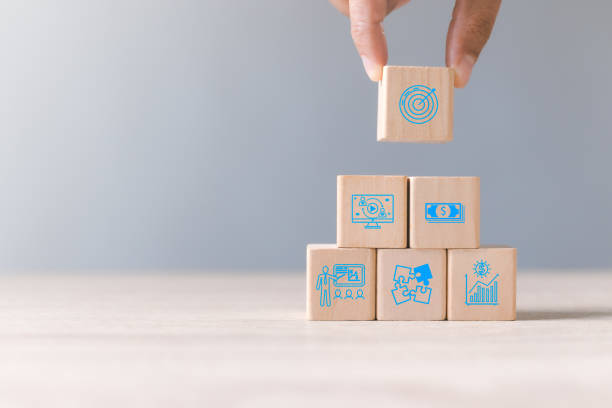 istock Hand is stacking wood block with icon about business strategy and action plan. Dartboard and arrow for set up business objective target. Goal and targeting the business concept. Copy space. 1468447451